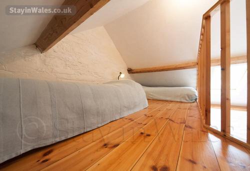 Mezzanine bedroom with two single beds, suitable for children